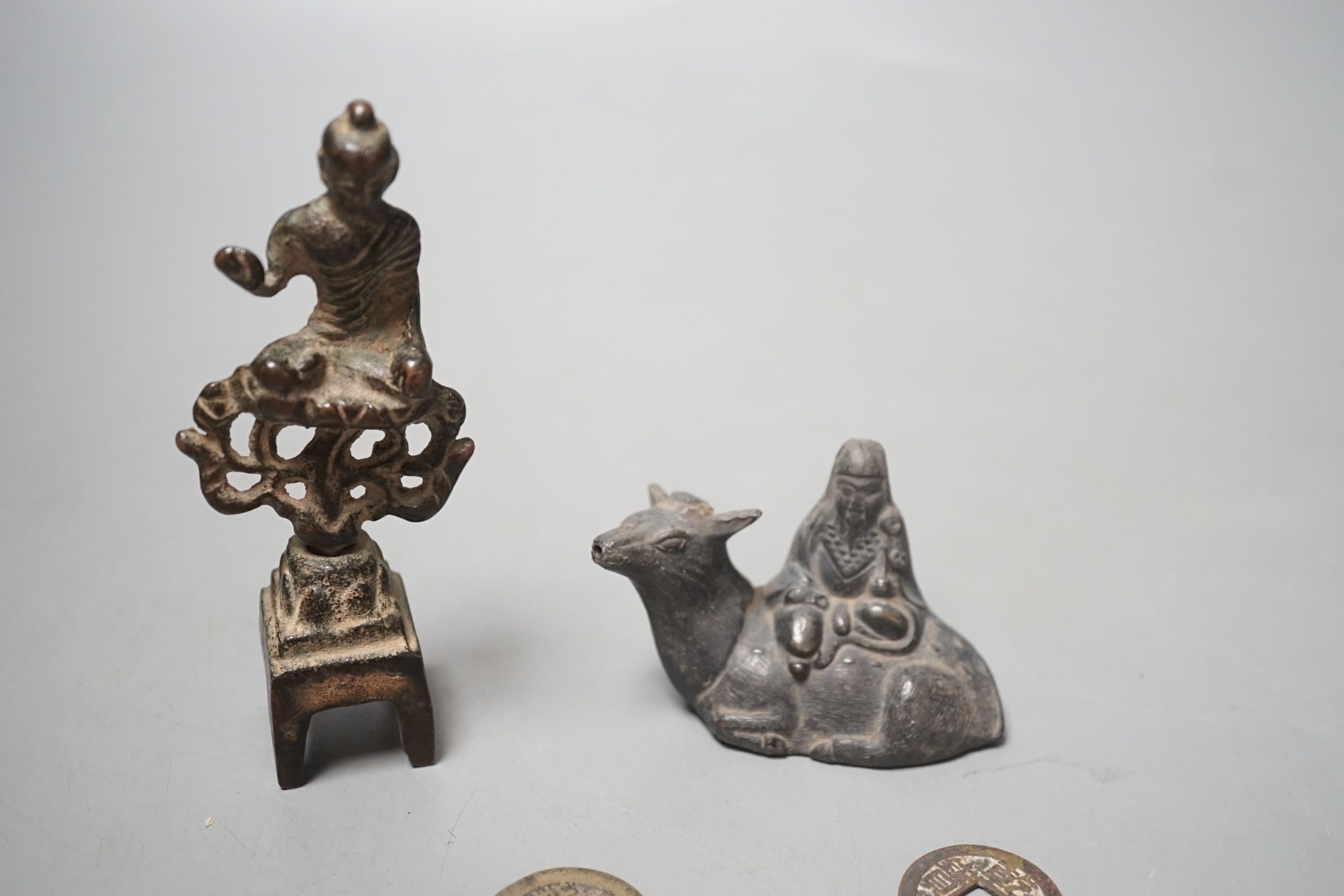 A collection of Chinese coins, together with a water dipper in the form is a seated animal, and a seated Buddha (7)